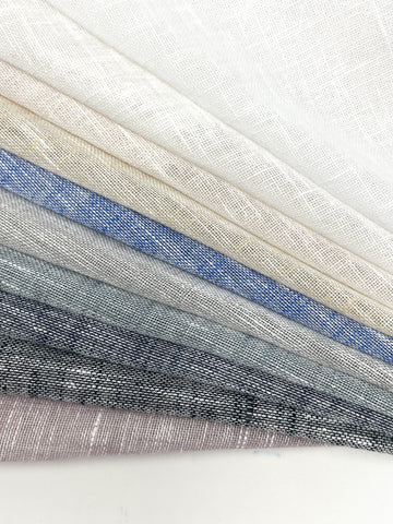 Folded swatches of two-tone poly linen sheer fabric in white, ivory, blue, gray, and natural tones.