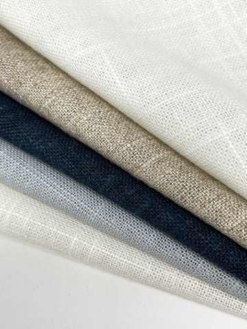 Stack of medium sheer vintage linen blend fabrics in shades of ivory, taupe, gray, and charcoal.