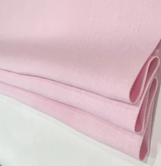 Close-up of pink linen fabric with a white background
