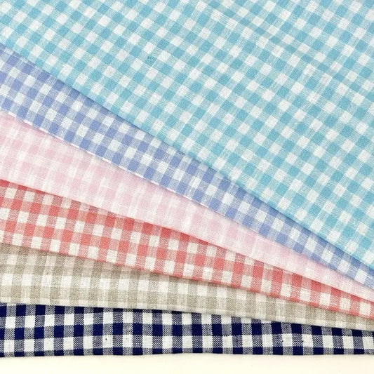 Four different colored gingham check fabrics arranged in a row.