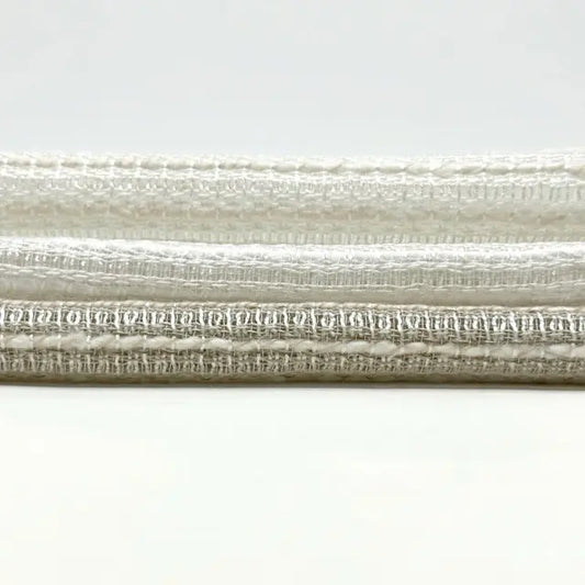 Close-up of textured beige linen fabric on a white background
