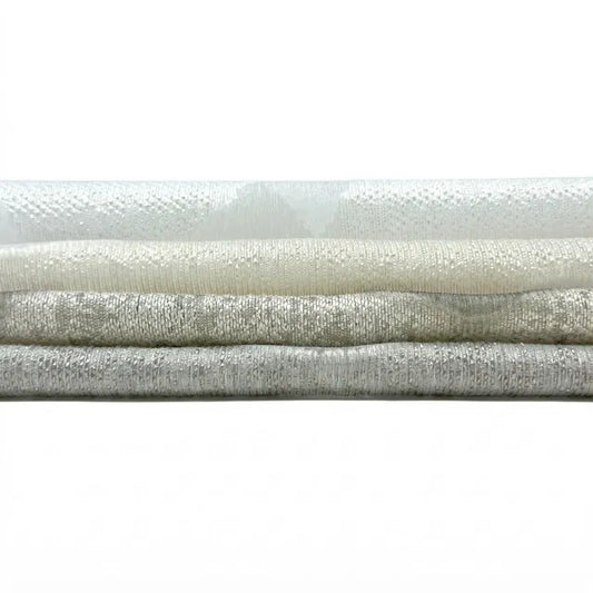 Collection of textured white linen fabrics stacked on a white background