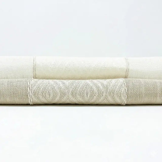 Stack of folded white towels on a light gray background