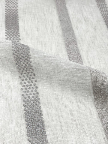Sheer linen fabric with vertical dotted and textured stripe embroidery in beige tones, shown in close-up view.