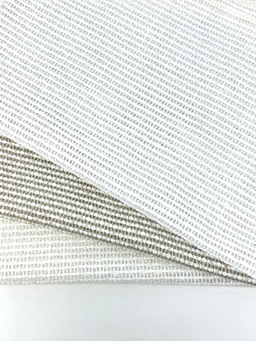 Linen blend net sheer fabric with a loose open weave in neutral tones, layered to show texture.