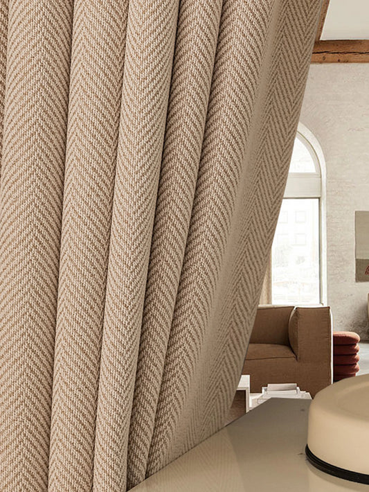 Textured beige curtain in a living room setting with a sofa and coffee table.