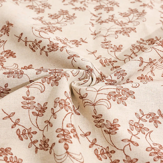 Close-up of beige fabric with subtle brown floral pattern