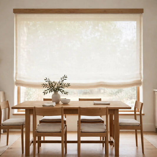 Ivory sheer linen flat Roman shade half raised in a bright dining room