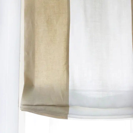 Beige roman shade partially drawn on a white background