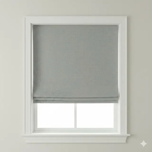 Window with a gray roman shade on a plain wall