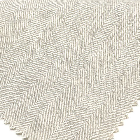 Herringbone natural linen fabric in a neutral tone, ideal for curtains, drapery, and home decor.