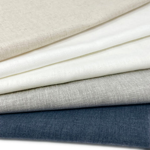 Classic Blend Linen Fabric in neutral shades including cream, white, gray, and navy, displayed folded.