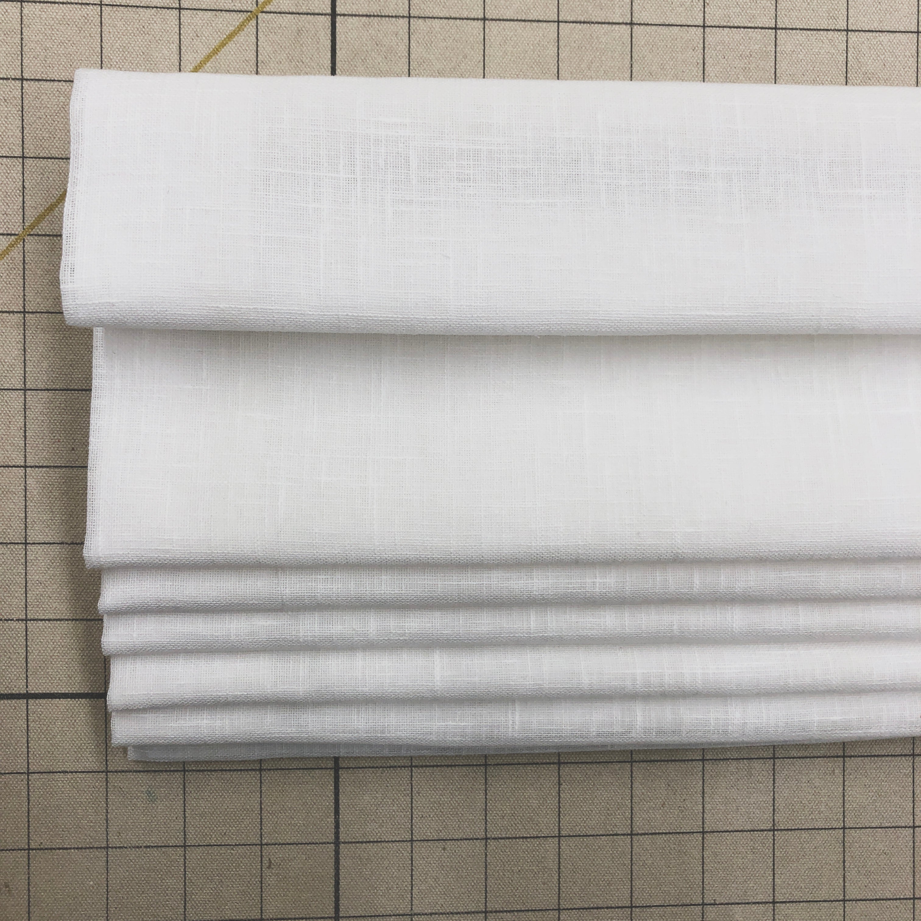 Contemporary White blend linen flat roman shade on the work table