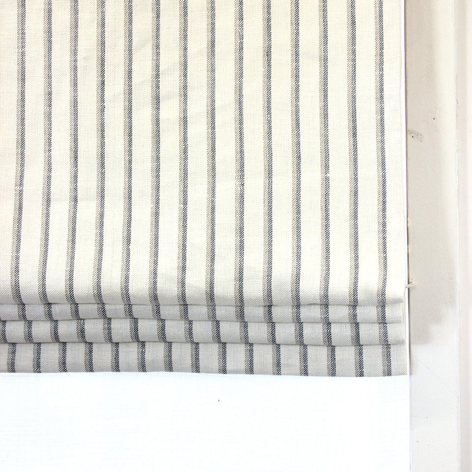 cream off white linen flat roman shade with light grey and dark grey striped.