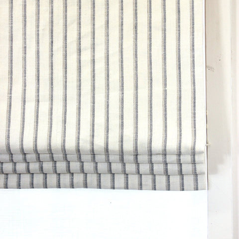 cream off white linen flat roman shade with light grey and dark grey striped.