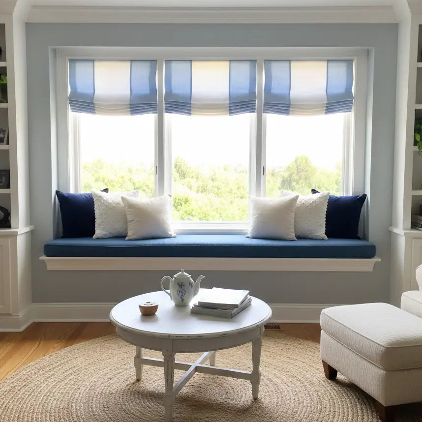 Blue white relaxed roman shade in living room.