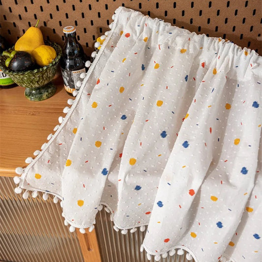 Cotton daisy café curtain fabric detail with colorful dot print and tassel trim