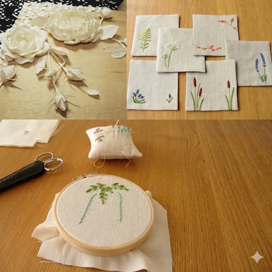 Embroidery hoop with floral design, embroidered coasters, and scissors on a wooden surface.