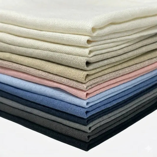 Stack of folded linen fabric swatches in various colors on a white background