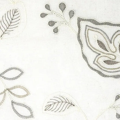 Close-up of embroidered floral patterns on a white fabric background