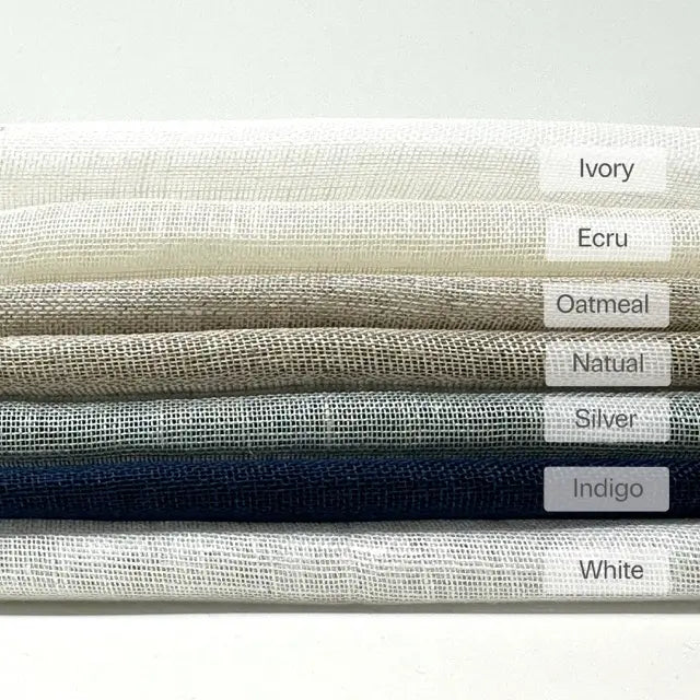 Folded open weave sheer linen fabric labeled in Ivory, Ecru, Oatmeal, Natural, Silver, Indigo and White