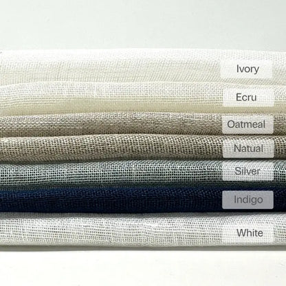 Folded open weave sheer linen fabric labeled in Ivory, Ecru, Oatmeal, Natural, Silver, Indigo and White