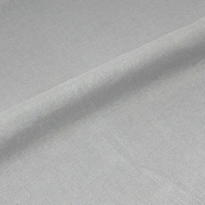 A close-up of light gray fabric with a soft diagonal fold showing the material texture.