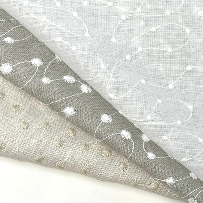 Embroidery Filigree Blend Linen fabric in neutral tones with delicate stitched floral and swirl patterns.