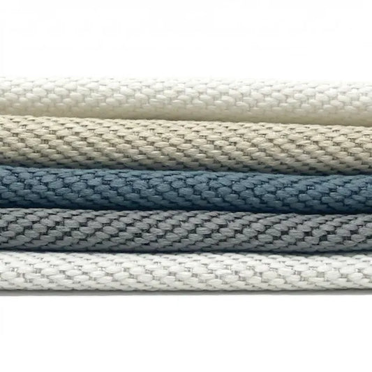 Stack of linen fabrics in various colors on a white background