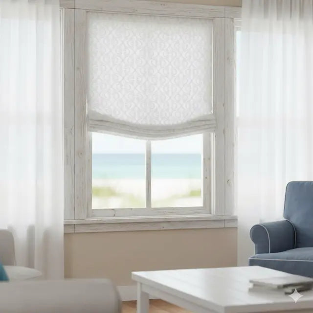 Living room with a window featuring a classic woven scroll white linen flat roman shade, light-colored walls, and a blue armchair.