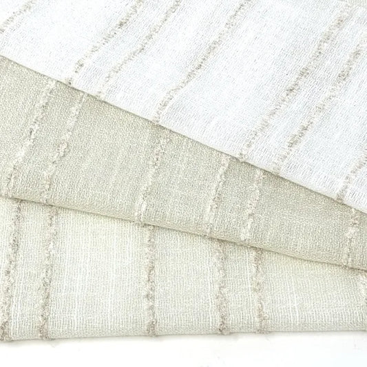Close-up of textured fabric with horizontal stripes in beige and white.