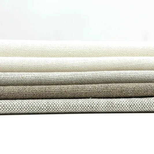 Stack of textured fabric swatches in beige and gray on a white background