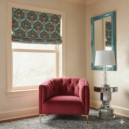 Living room with a red armchair, damask floral velvet roman shade, and decorative mirror.