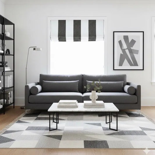 Modern living room with a wide stripe contemporary flat roman shade, a gray sofa, coffee table, and abstract art on the wall.
