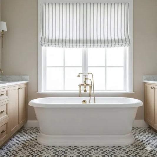 White freestanding bathtub in a bathroom with a window and striped curtain.