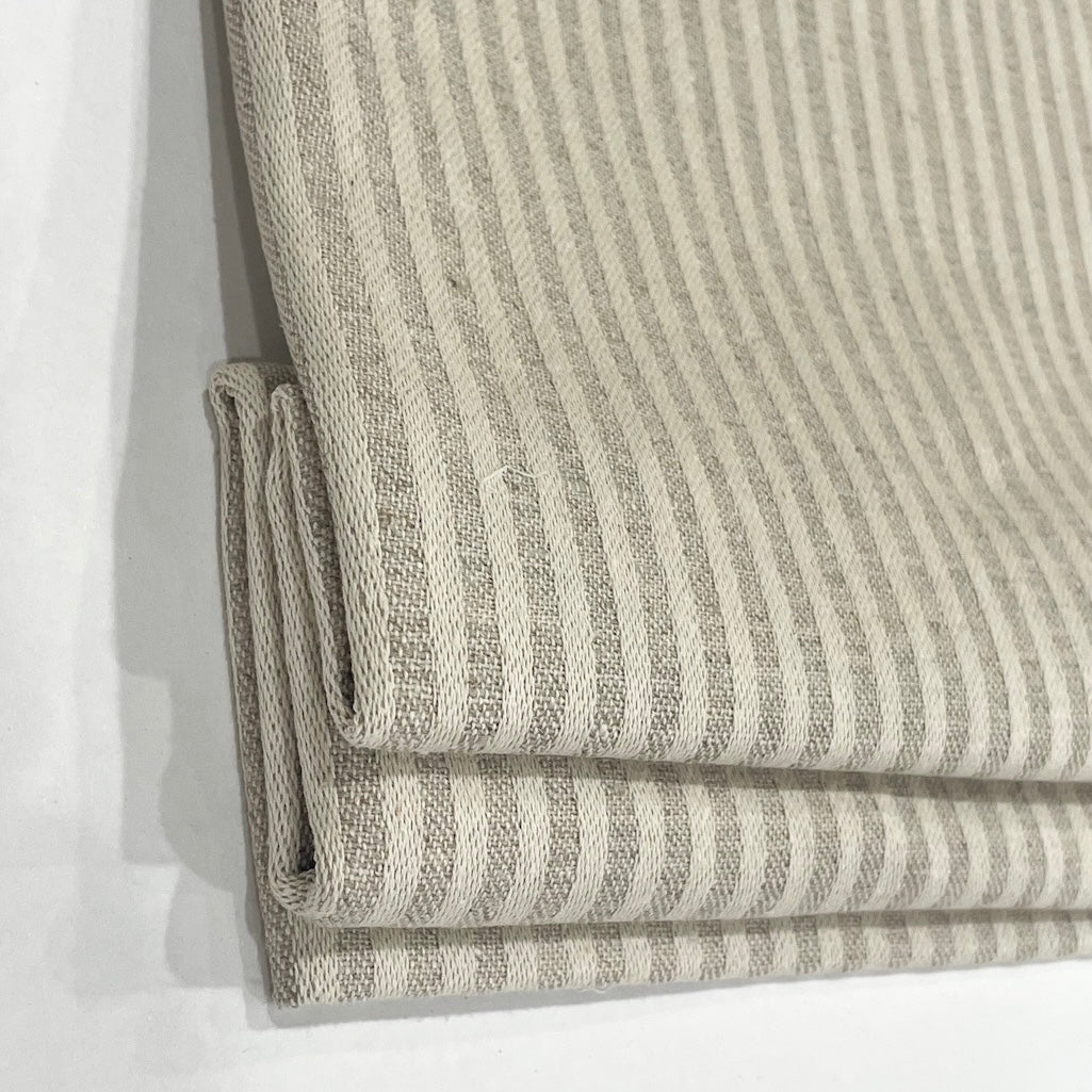 Folded fabric with a striped pattern on a white background