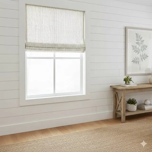 Window with a roman shade in a room with wooden flooring and a small table with decor items.