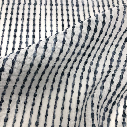 Close-up of sheer linen fabric with dark vertical embroidered stripes on a white background, style CL1032.
