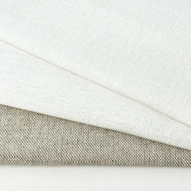 Close-up of white and beige fabric textures on a light gray background