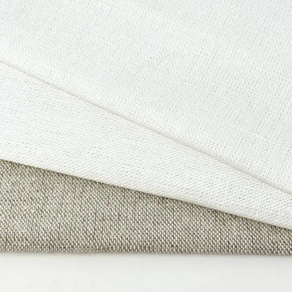 Close-up of white and beige fabric textures on a light gray background