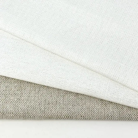Close-up of white and beige fabric textures on a light gray background