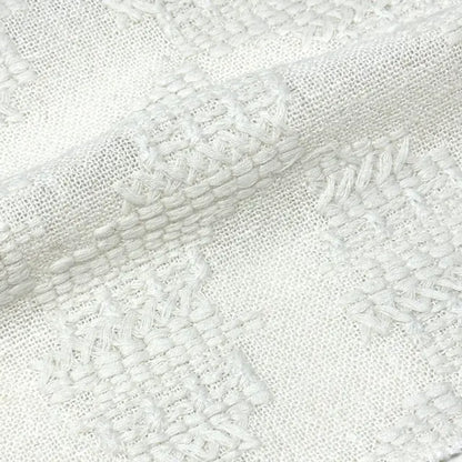 Close-up of textured white fabric with a diagonal pattern