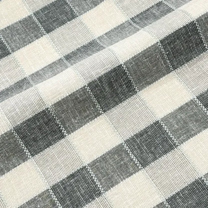 Close-up of a checkered fabric pattern with black and white squares.