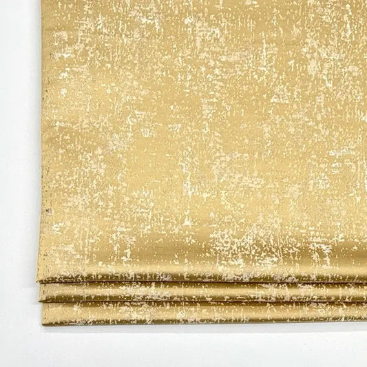 Gold textured fabric on a white background