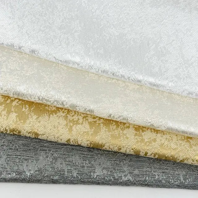 four different textured fabric samples on a white background