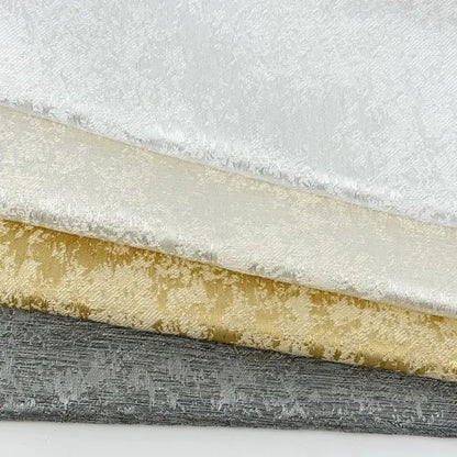 four different textured fabric samples on a white background