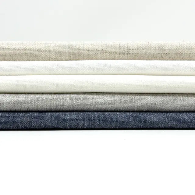 Stack of fabric swatches in various neutral colors on a white background