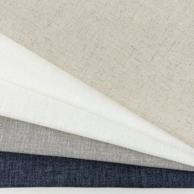 Four different fabric swatches in gray, white, and blue on a neutral background