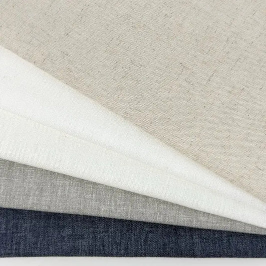 Four different fabric swatches in gray, white, and blue on a neutral background