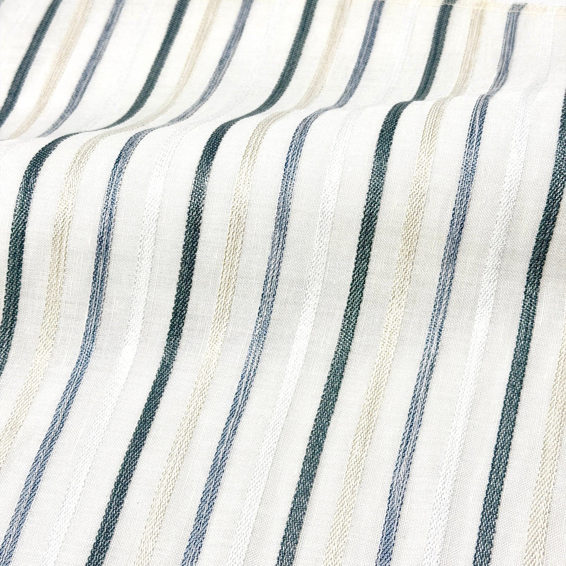 Close-up of fabric with Vertical stripes in white, gray, and beige.